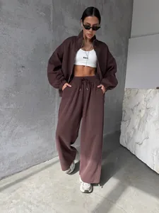 Modèle portant un ensemble de survêtement marron deux pièces avec veste et pantalon large