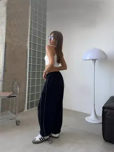Women's casual black sweatpants with a loose street style fit and elastic waist