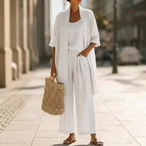 Elegant white linen three-piece suit set for women featuring a loose cardigan and pants