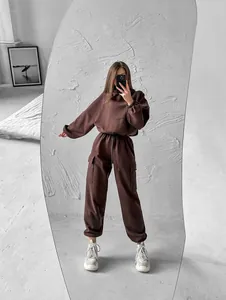 Full body view of a woman wearing a chocolate brown hoodie and cargo joggers tracksuit
