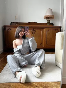 Lifestyle detail of grey two-piece lounge set featuring a zip-up hoodie and sweatpants
