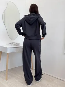 Back view of women's dark grey two-piece hooded sweatshirt and wide-leg sweatpants set