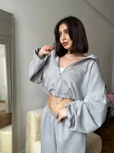 Close-up of women's grey leisure set featuring cropped zipper hoodie with drawstring