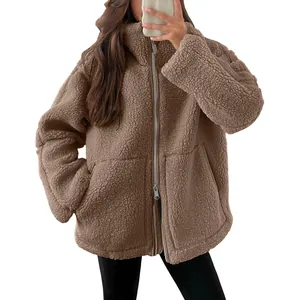 Close-up detail of brown sherpa fleece zip-up jacket with soft texture and pockets
