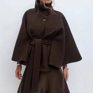 Detailed macro view of an elegant brown wool cape coat with chic high collar and belt