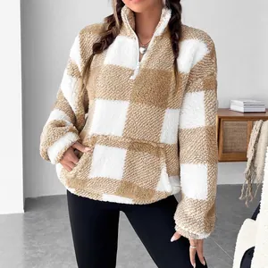 Detail shot of a cozy tan and white checkerboard sherpa fleece pullover
