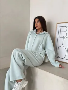 Stylish women's mint green two-piece cotton tracksuit with zip-up hoodie and wide-leg pants