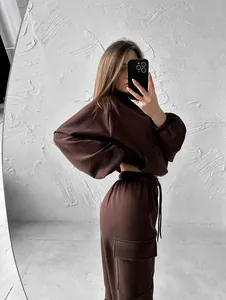 Stylish brown two-piece sports hoodie and cargo sweatpants set for women in mirror selfie.