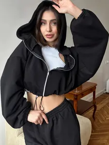 Stylish women's black 2-piece cropped zip-up hoodie and sweatpants set shown on a model