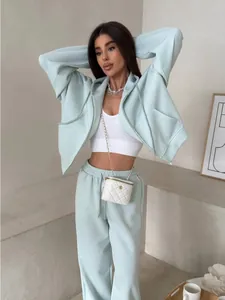 Full-body view showing the fit of a mint green sporty hooded set with drawstring pants