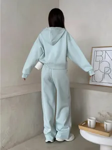 Back view of woman in light blue hooded sweatshirt and wide-leg pants loungewear set