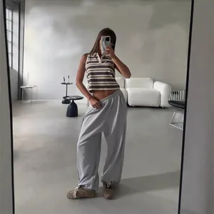 Women's American street style baggy grey sweatpants and striped sleeveless crop top