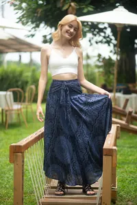 Boho style navy blue printed maxi skirt with tie waist worn in an outdoor garden.