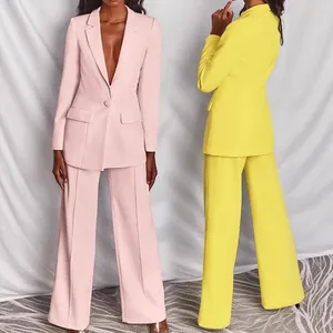 Close-up of a stylish two-piece women's blazer suit set in pastel pink and vibrant yellow