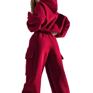 Back view of a fashionable deep red women's sports hoodie and cargo sweatpants set for winter