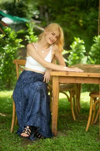 Full length bohemian floral print maxi skirt worn by a model in a lush green garden