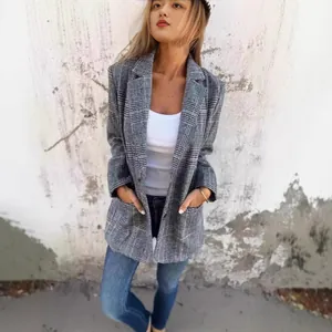 Detailed view of a stylish grey plaid blazer featuring a single button and front pockets.