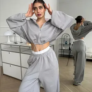 Stylish grey two-piece casual set featuring a cropped zip hoodie and loose pants