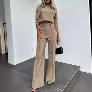 Full body view of a stylish khaki two-piece set with cropped top and wide-leg trousers.