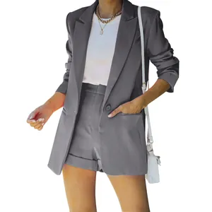 Elegant detail view of a women's two-piece gray blazer and shorts set with lapel collar.