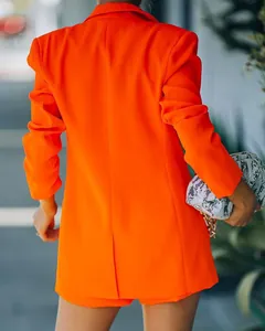 Rear view of a vibrant orange blazer and shorts suit set for a stylish summer look.