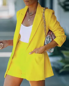 Detailed view of women's bright yellow blazer and matching high-waisted shorts set