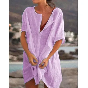 Close-up of the relaxed fit and linen texture of a lavender button-down beach cover-up