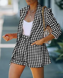 Close-up view of a stylish black and white houndstooth blazer and shorts suit set for women.