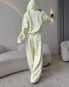 Women's minimalist pale yellow two-piece cotton tracksuit with hoodie and wide-leg pants