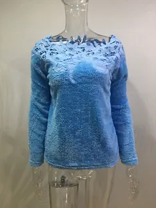 Blue long-sleeved sweater featuring delicate lace floral cutout at the neckline.
