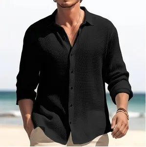 Close-up of men's black waffle textured long sleeve casual shirt with button-down front