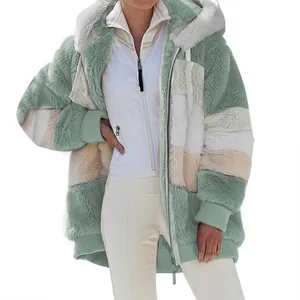 Close-up detail shot of cozy color-block oversized hooded fleece jacket for women in winter
