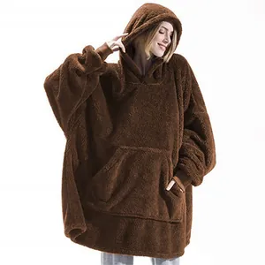 Close-up of oversized brown plush wearable blanket hoodie with large front pocket.
