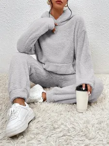 Close-up showing the soft grey teddy fleece fabric and pocket detail of the loungewear set