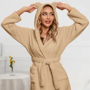 Detailed view of a soft beige plush bathrobe featuring a cute bear ear hood for women