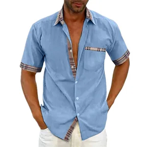 Detail view of men's blue short sleeve shirt featuring stylish plaid trim on collar and pocket