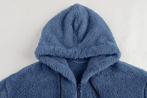 Detail view of a blue plush hooded jacket showing the soft texture and zipper.