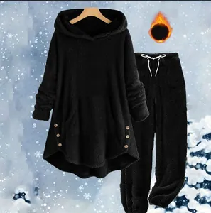 Close-up of black fleece hoodie and jogger set designed for winter warmth and comfort.