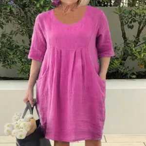 Detail view of a fuchsia linen-style dress featuring a round neck and convenient pockets