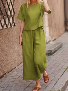 Casual olive green linen two-piece set featuring short sleeve top and wide leg pants