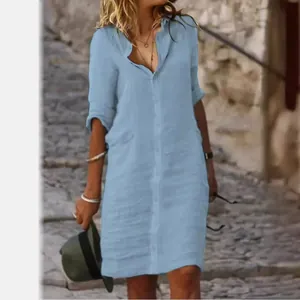 Loose light blue cotton linen shirt dress with lapel and buttons for women.