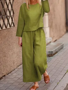 Detailed view of moss green linen-style two-piece set with loose-fit top and trousers