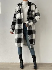 A full view of the long black and white buffalo plaid sherpa coat on a model.