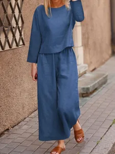 Detail of loose fit blue linen two-piece set with long sleeves and wide leg pants