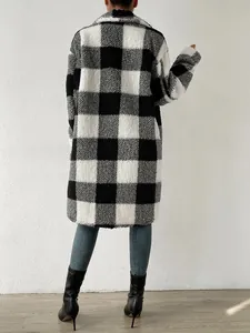 Rear view of a long black and white plaid fuzzy coat with a loose fit silhouette