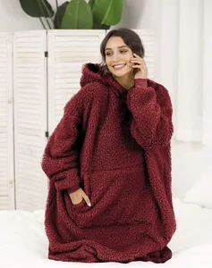 Detail of soft burgundy Sherpa fleece oversized hoodie blanket with large pocket and hood