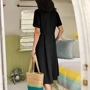 Back view detail of a minimalist black short-sleeve cotton linen high-waisted midi dress