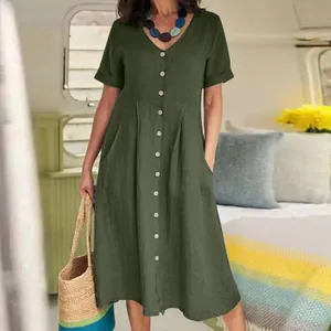 Detail of a green cotton linen dress featuring a V-neckline and button-down front.