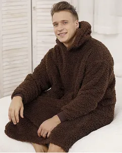 Close-up of the plush Sherpa texture and oversized fit of this brown hooded blanket