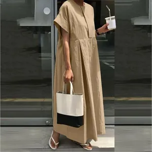 Close-up of a loose khaki cotton linen maxi dress with a relaxed Mori girl style.